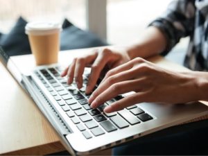 Image of hands typing on laptop